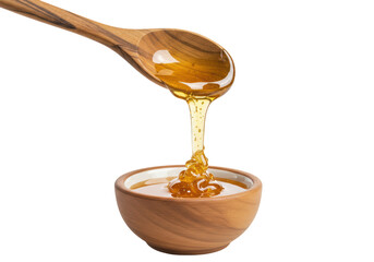 Isolated golden honey drips from wooden spoon into wooden bowl, dripping honey sweet