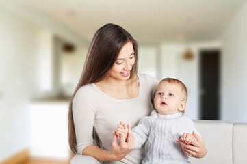 Mother with cute small baby in living room
