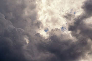 Gray cloud diffuses sunlight close-up. The struggle of opposites: light and darkness.