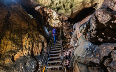 Woman climbing cave stairs