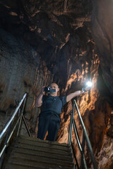 Fototapeta premium Tourist photographing cave interior