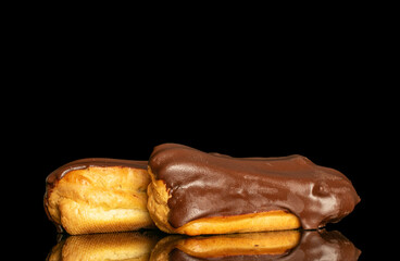 Chocolate sweet eclair, macro, isolated on black  background.