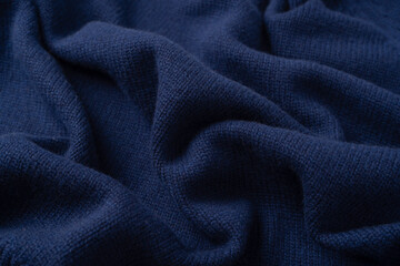 Navy blue merino wool sweater texture as background. Top view.