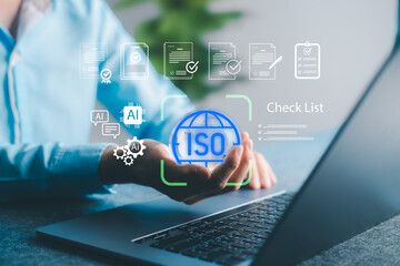 Businessman using laptop with virtual ISO certification, AI integration, checklist icons, representing digital compliance, quality assurance, and smart documentation.
