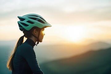 A cyclist gazes at a serene sunset, wearing a helmet, symbolizing adventure and the beauty of nature.