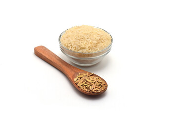 FRESH RICE ON WOODEN SPOON AND BOWL ISOLATED ON WHITE BACKGROUND.