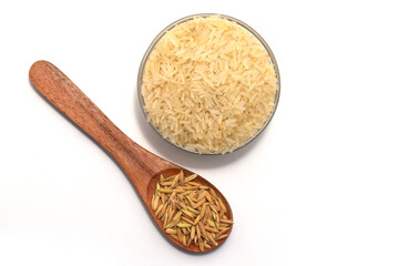 RICE AND RICE GRAIN ON BOWL AND SPOON ISOLATED ON WHITE WITH TOP VIEW.