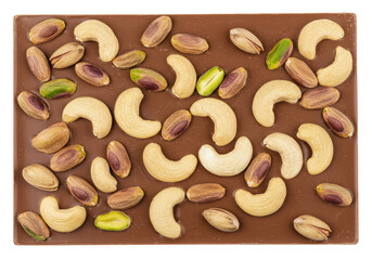 Isolated bar of gourmet milk chocolate with cashew nuts and pistachios, delicious dessert