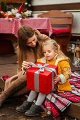 happy family of mother and daughter celebrating Christmas near the trailer with Christmas decorations
