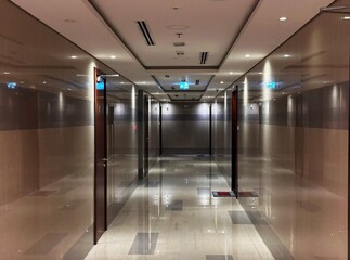 Contemporary hallway with polished marble walls and ceiling lighting. Concept of business, real estate and corporate building interiors. 