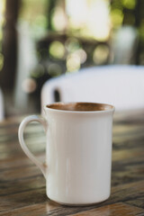 Latte in White Cup on Wooden Table. Cozy Latte Coffee Cup on Wooden Background. Morning Latte in Ceramic Mug on Wood Table.