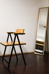 Minimalist Contemporary Interior Featuring Wood and Metal Chair with Mirror Element