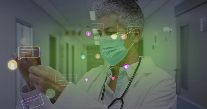 Viewing doctor tapping smartphone under hospital lights, with floating chat icons and stethoscope - Powered by Adobe