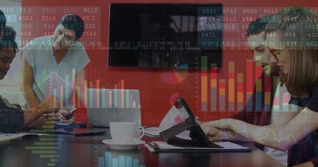 Collaborating business team reviewing charts in modern conference room, with tablets and coffee mug