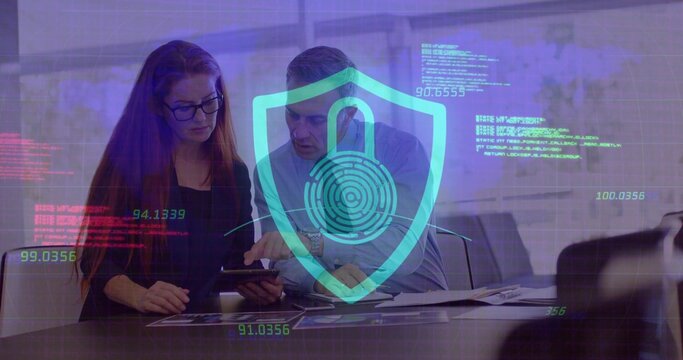 Male and female colleagues analyzing data on tablet in meeting room, with digital security graphics