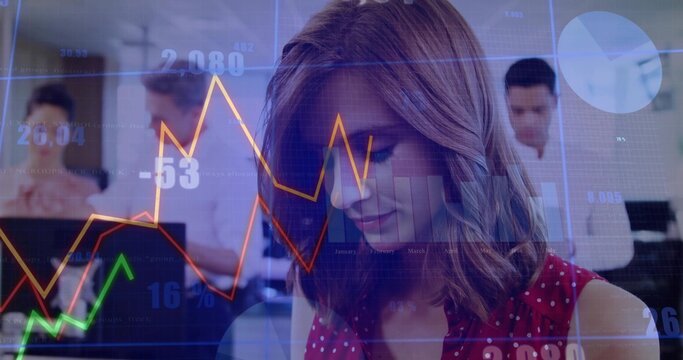 Woman in red polka dot blouse analyzing financial data in open office, with laptops, chart overlays