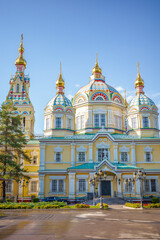Bright and colorful view of Zenkov Cathedral, a famous wooden Orthodox church in Almaty, Kazakhstan. With its golden domes, intricate patterns, and vibrant design in Central Asia