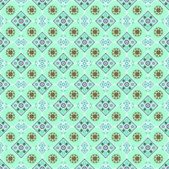 Seamless pattern with a tribal or folk art aesthetic. Alternating motifs on a light mint green background. Yellow, purple and blue. Use for fabric prints, wallpaper, stationery or children's textiles.