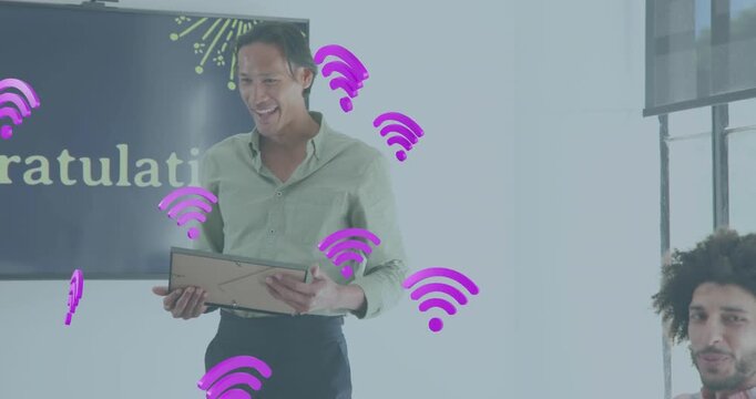 Floating Wi-Fi icons sparking celebration as man presenting certificate to coworker in office