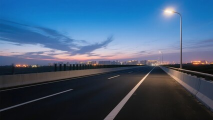 Empty highway at dusk with city skyline in the distance