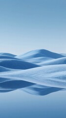 Snow-covered dunes under a clear blue sky, reflecting in calm water