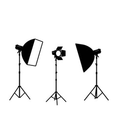 Professional photography studio lighting equipment set on tripods for creative shoots isolated on white background