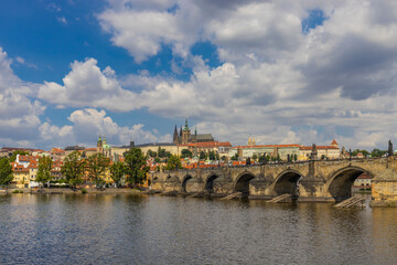 Prague cityscape, the capital of Czech Republic tourist sights. Prague historic center district at Charles bridge during the day. Busy tourist area city sights of Prague, capital of Czech