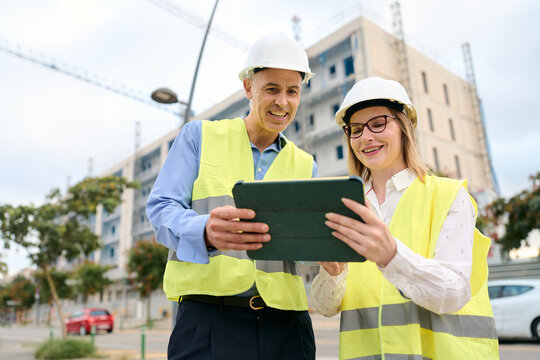 Engineers using tablet planning construction at site