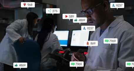 Male scientist tapping tablet in lab, generating data icons to refine metrics as colleagues type - Powered by Adobe