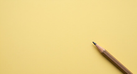 Single Graphite Pencil on Pale Yellow Background: Minimalist Stationery Mockup