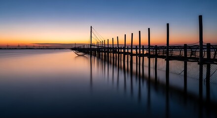 Obraz premium Serene Sunset over Calm Water with Wooden Dock.