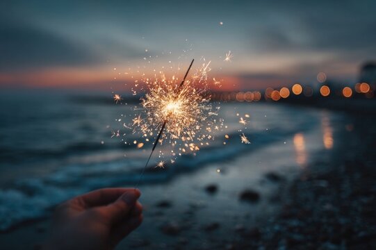 Womana??s hand holding sparkler during Diwali celebration, night sky and warm atmosphere
