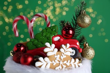 Happy Saint Nicholas day. Festive decor and sweets against green background with blurred lights, closeup