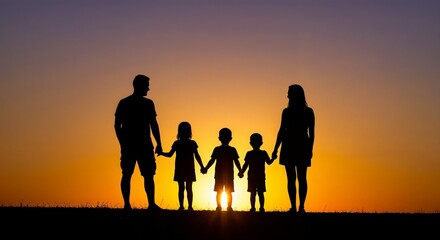 Family holding hands while standing silhouetted against sunset  