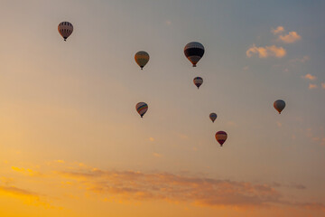 Three hot air balloon against a morning sky. Beautiful view of colourful hot air balloons from below