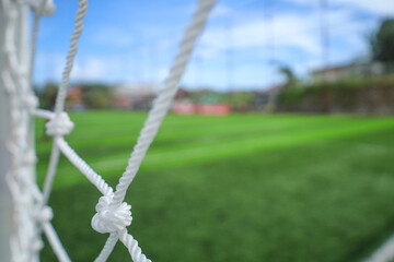 Selective Focus Close up Soccer Goal Net with Green Field