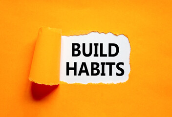 Build habits symbol. Concept word Build habits on beautiful white paper. Beautiful orange paper...