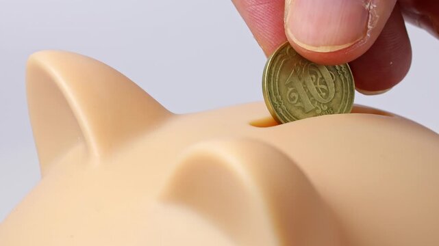 Close up view of man hands, piggy bank, Turkish lira coins kurus. Concept of saving money for retirement, cash settlement, financial goals, success, literacy and income planning in Turkey.
