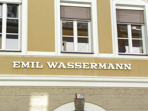Lienz, Austria - September 18, 2025: Emil Wassermann sign on a historic building facade, showcasing elegant architecture and vibrant colors in an urban setting with windows and decorative elements