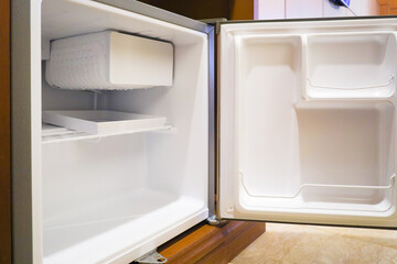 Fototapeta premium Bright Empty Mini Refrigerator with Open Door Interior Appliance View