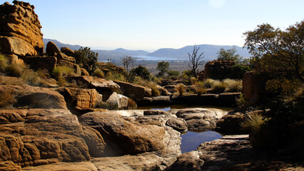 Landscape photo of stunning views from the Magaliesberg mountains, with interesting rock...