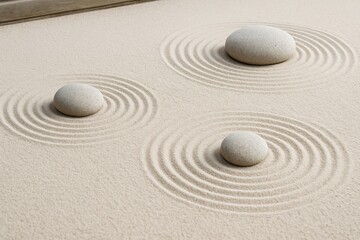 Obraz premium Three smooth stones placed in fine sand with concentric raked patterns, minimalistic style, on a neutral background. Concept of peace