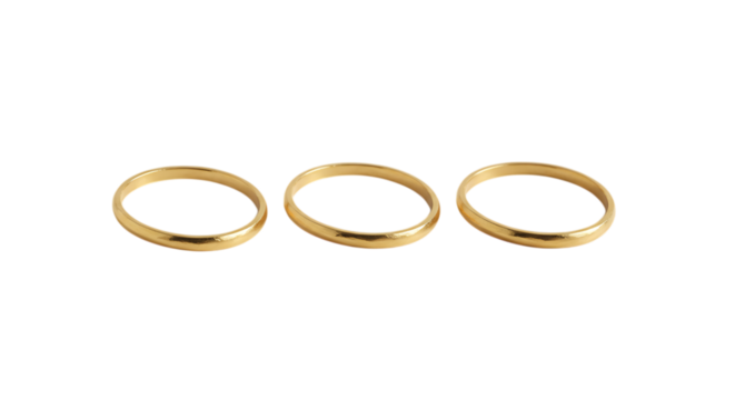 Three gleaming gold wedding bands arranged in a horizontal line isolated on white background