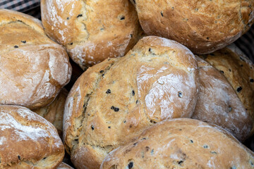 A basket of freshly-baked, artisan sourdough bread sits in a high angle view - perfect for healthy eating and tasty fast food.