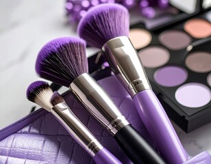 Makeup brushes and eyeshadow palette on marble