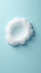 Minimalist ring of white cleansing foam on a pastel blue background.