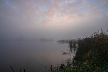 sunrise over the river with reflections clouds 