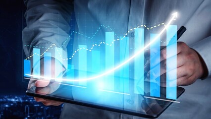 A business professional interacts with a tablet featuring a digital growth chart, symbolizing data analysis and success in a modern urban environment. Copula
