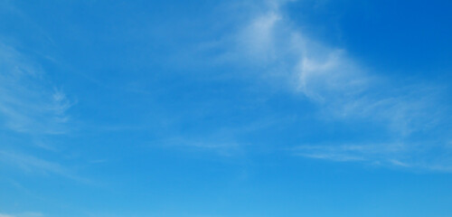 Serene blue sky with wispy clouds