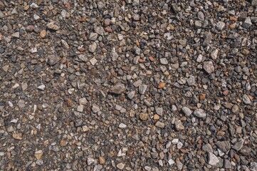 Close-up of vibrant granite fragments and crushed rock surface from above, showcasing a natural stone rubble texture with space for text